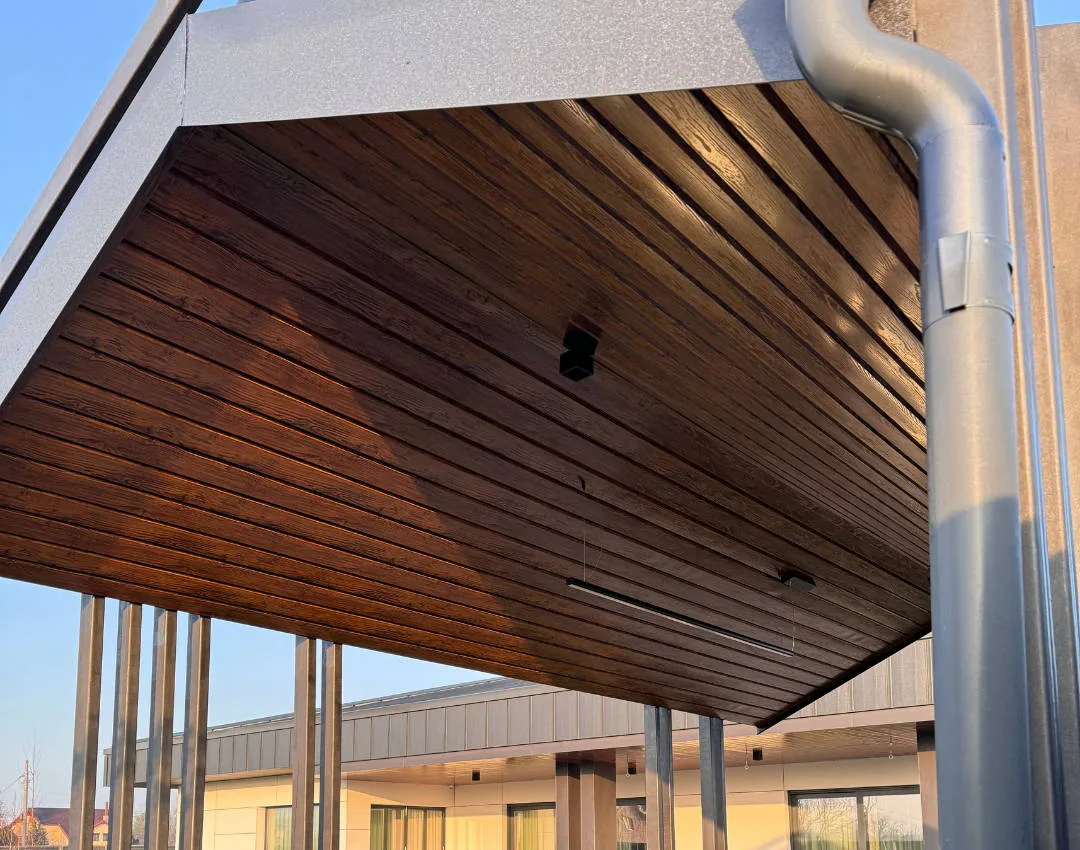 Soffit clad with woodgrain metal cladding