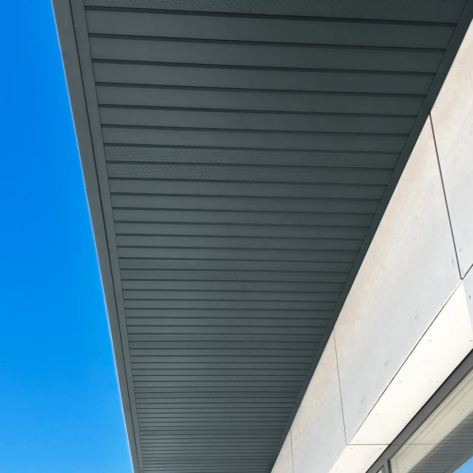 Soffit clad with grey metal cladding