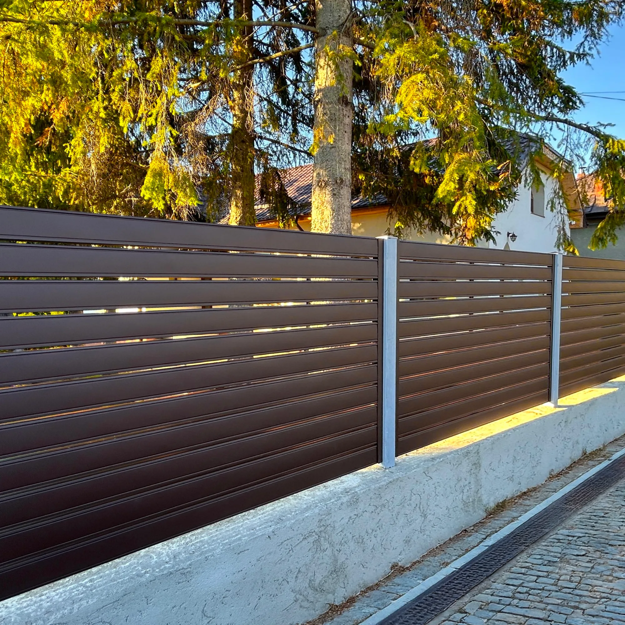 Chocolate brown Terra fence on a concrete wall