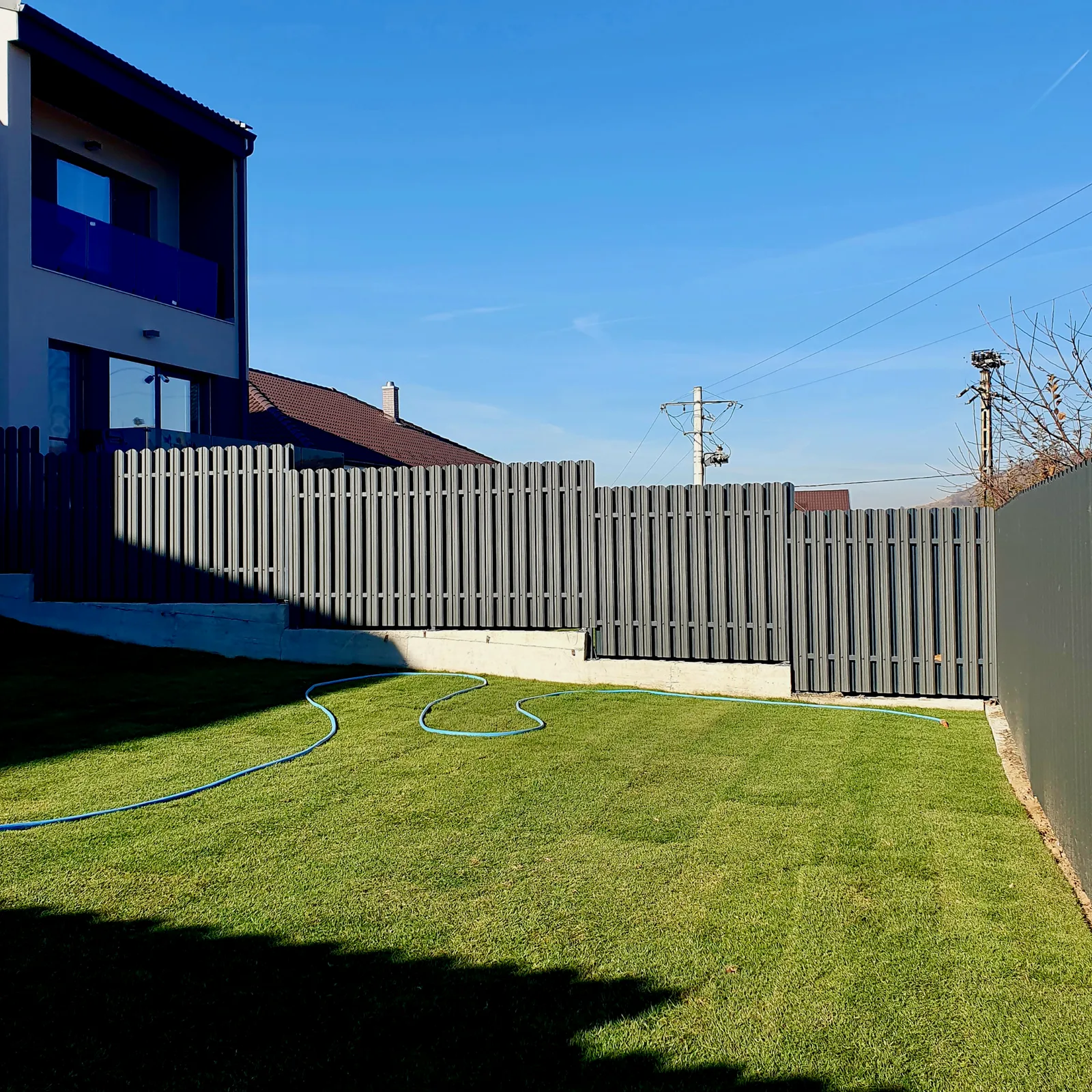 Graphite grey Tisa picket fence around a yard
